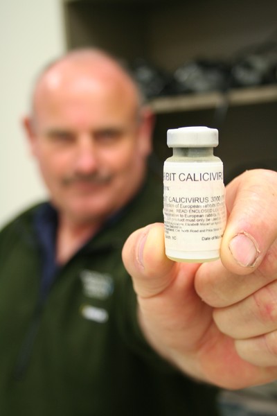 Mike Knight, a Kaitaia-based Pest Management Officer with the Northland Regional Council, holds a vial of the rabbit-killing calicivirus.